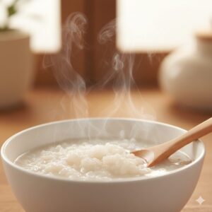 image 3 - A steaming bowl of nutritious rice porridge with a small wooden spoon