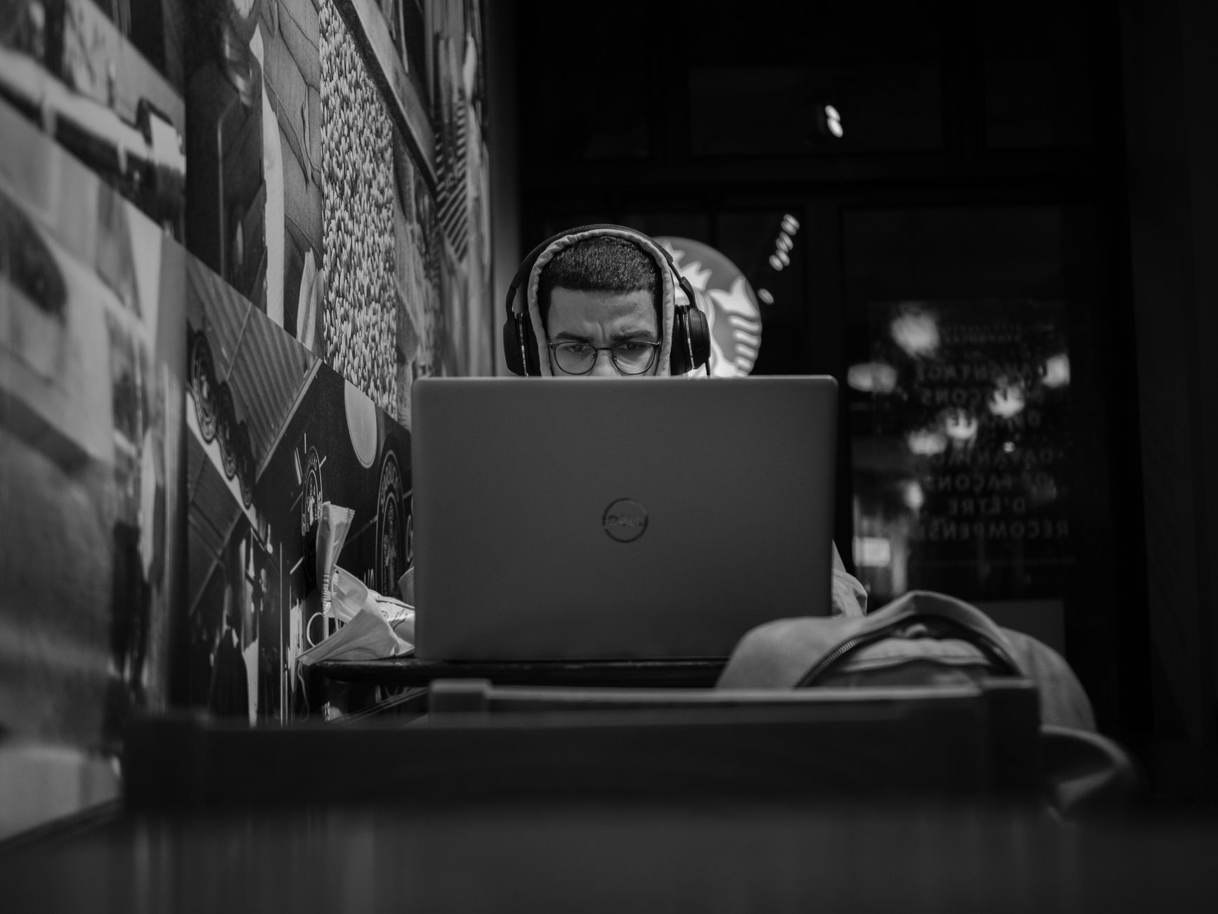A parent using noise-canceling headphones to stay focused while working from home.