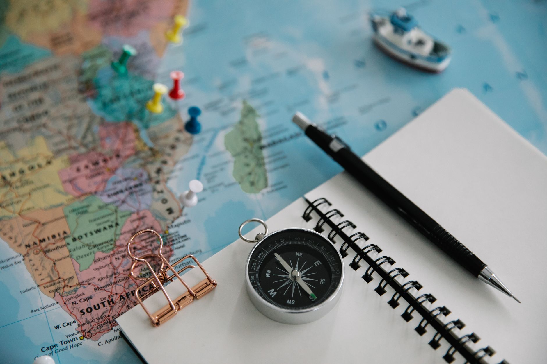 Planning a staycation with a map and notebook on a table.