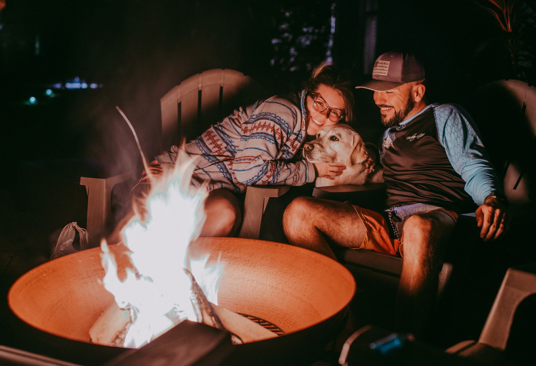 Family enjoying a campfire without digital devices.