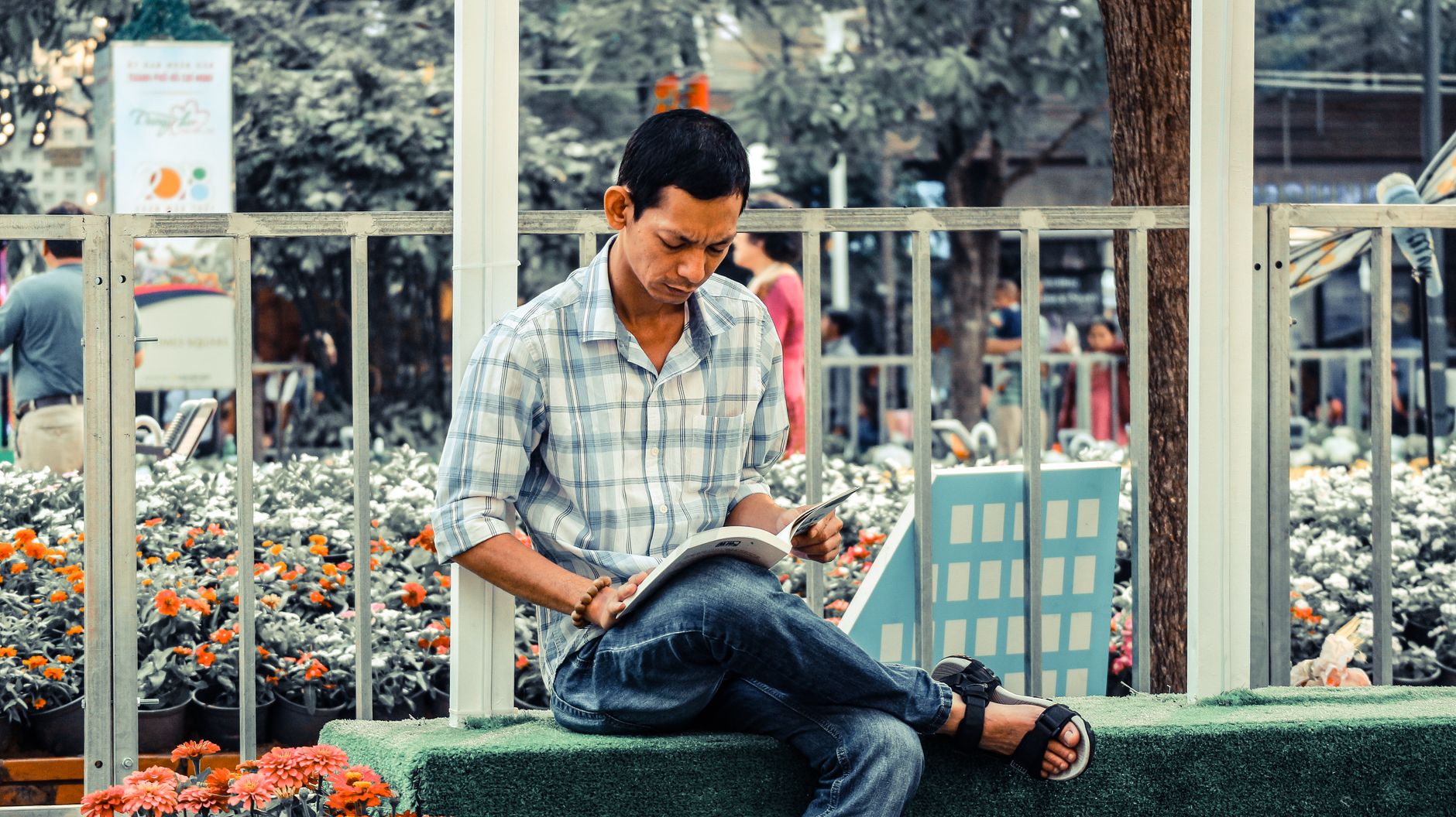 Person reading a book in a quiet outdoor setting.