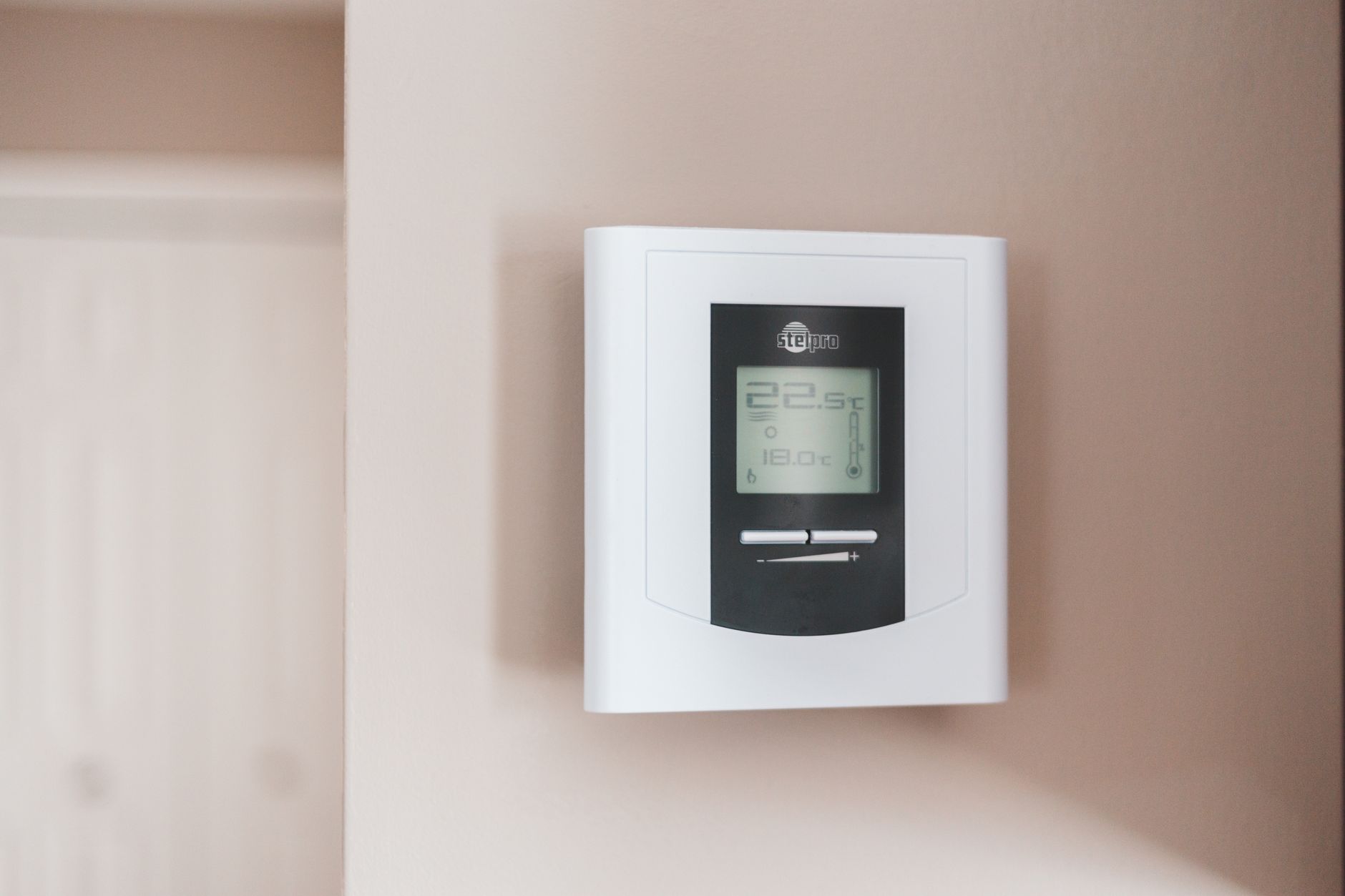 Smart thermostat installed on a modern home wall