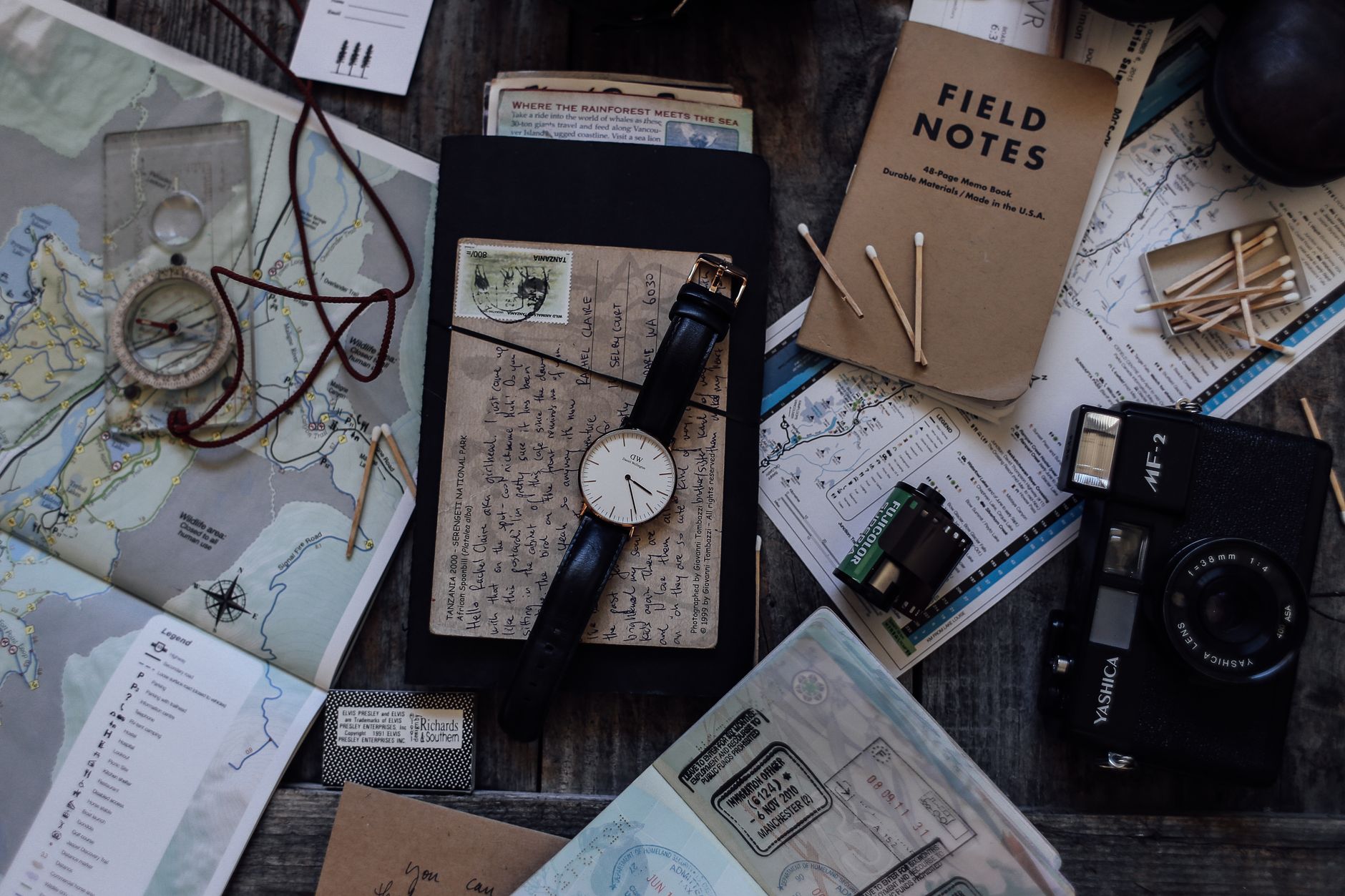 Travel planning tools on a wooden table.