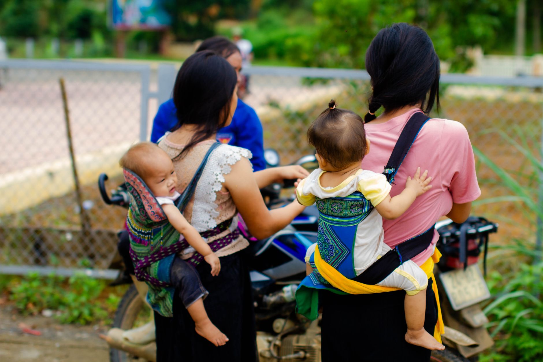 Close-up inspection of pre-loved baby carrier stitching.