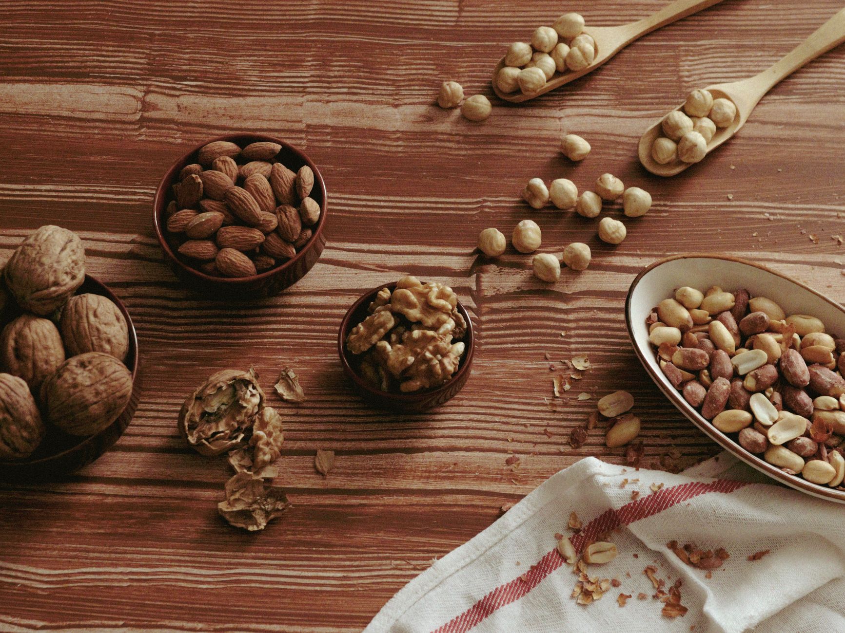 A variety of whole foods arranged on a rustic wooden table.