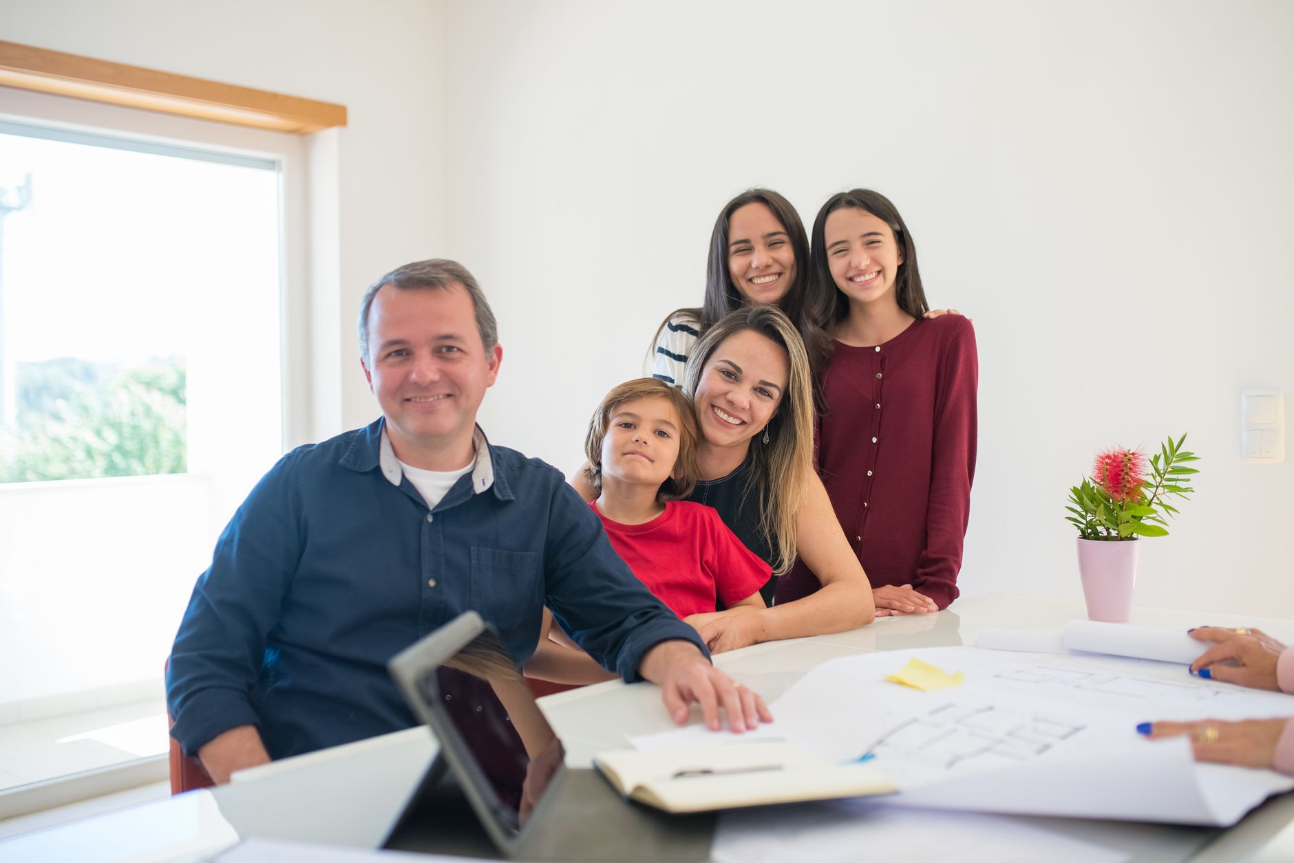 A family planning their home exchange trip on a laptop.