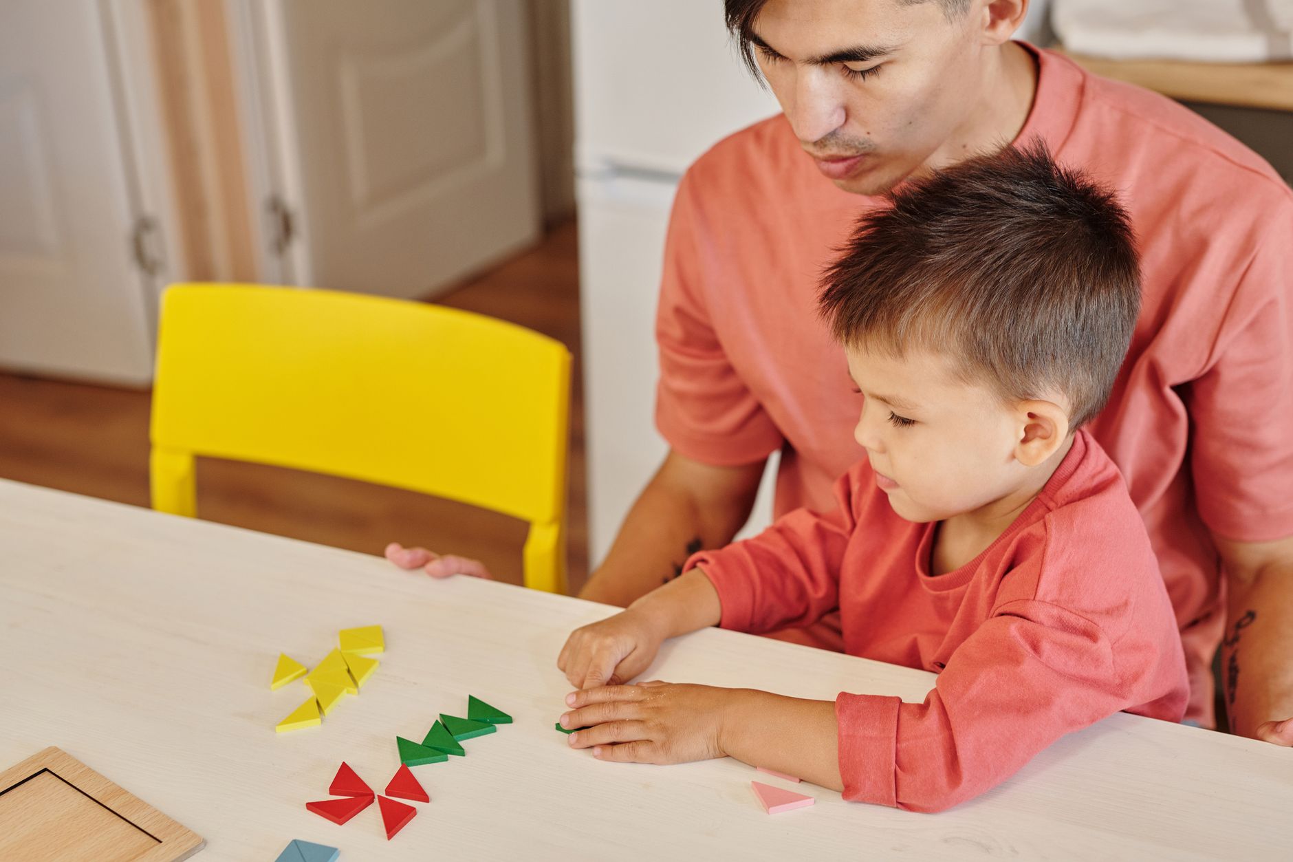 A parent and child engaged in a focused, calm play session.