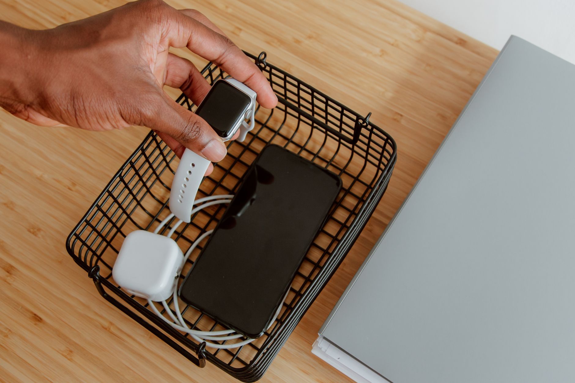 A basket collecting electronic devices to symbolize a digital detox.
