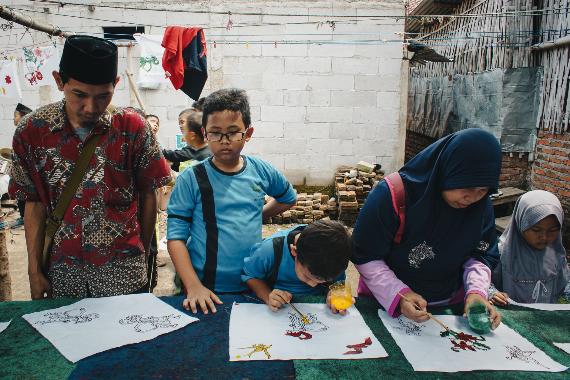 A family enjoying a hands-on cultural craft workshop during their travels.