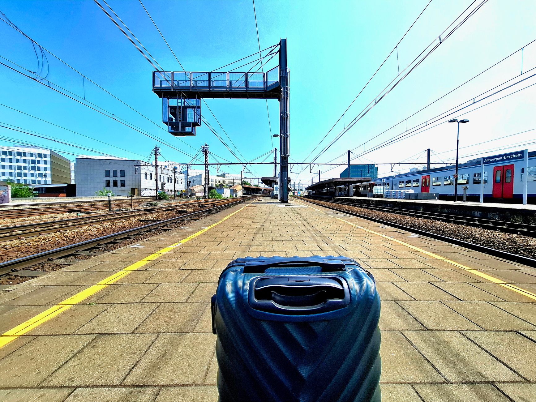 Travel luggage waiting on a European train platform.