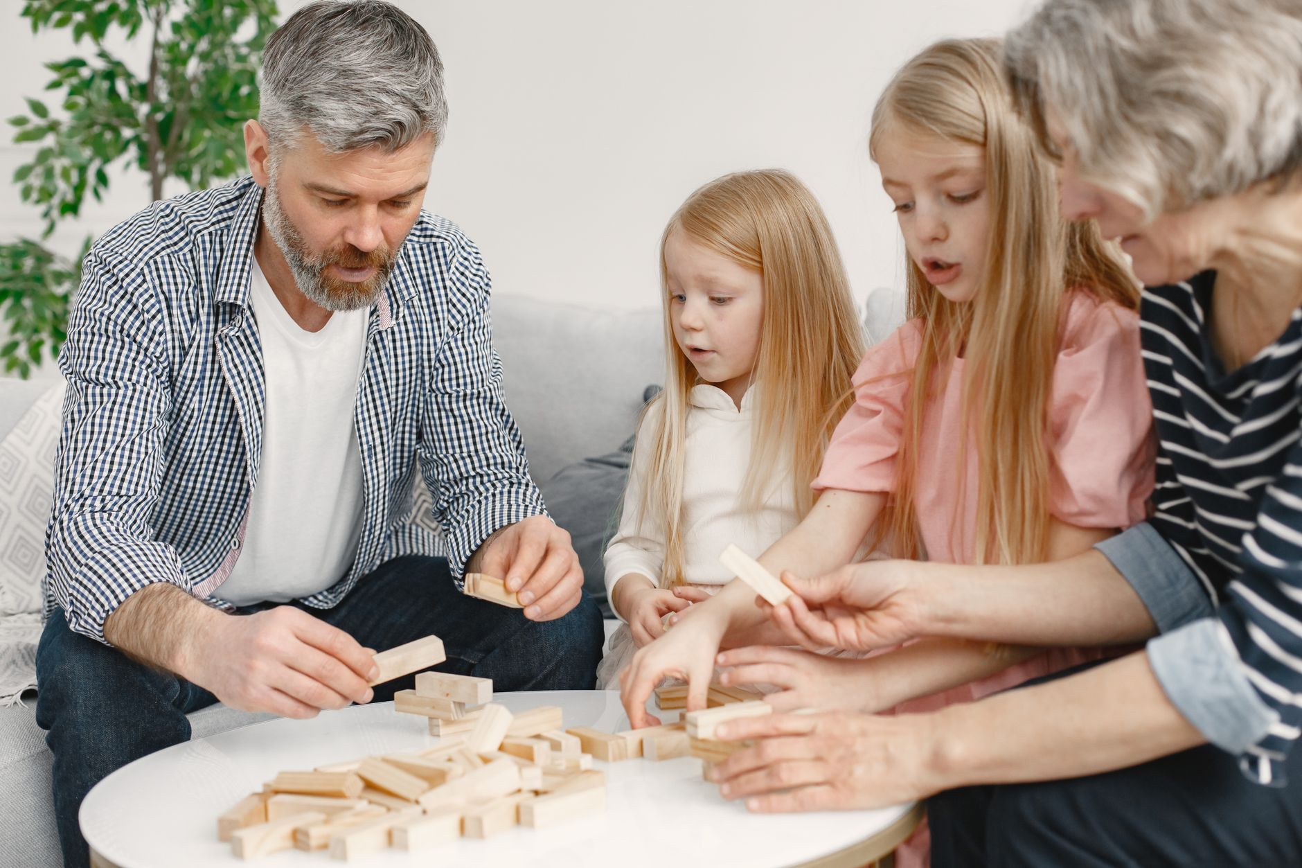 A grandparent watching a child play with blocks, representing observation and support.