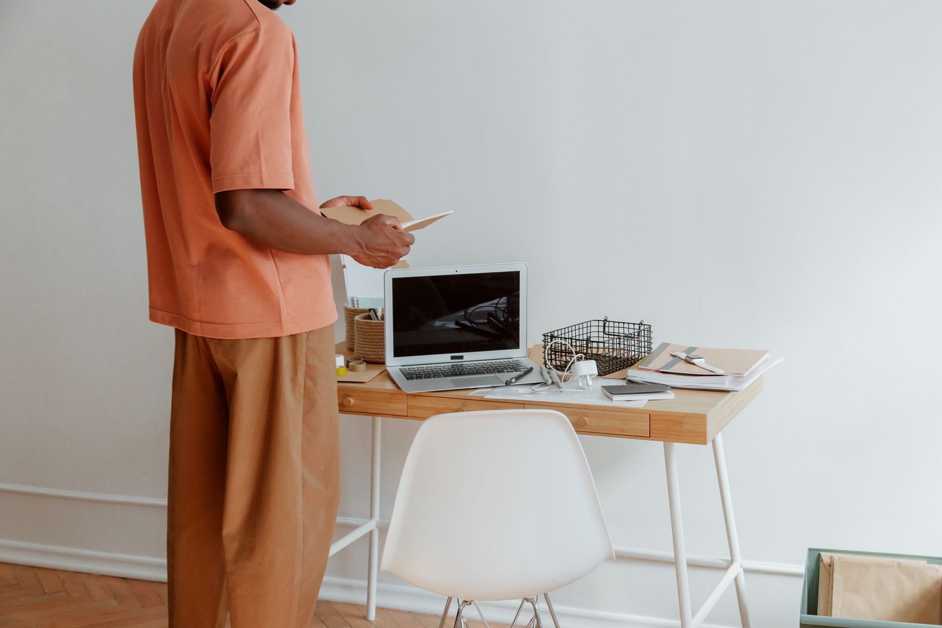 A home office desk being organized with ergonomic tools.