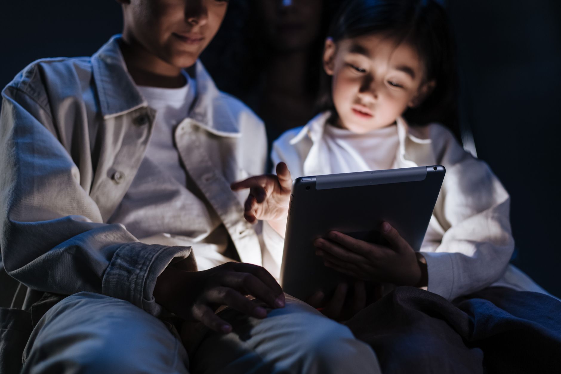 Family reviewing home energy usage data on a tablet