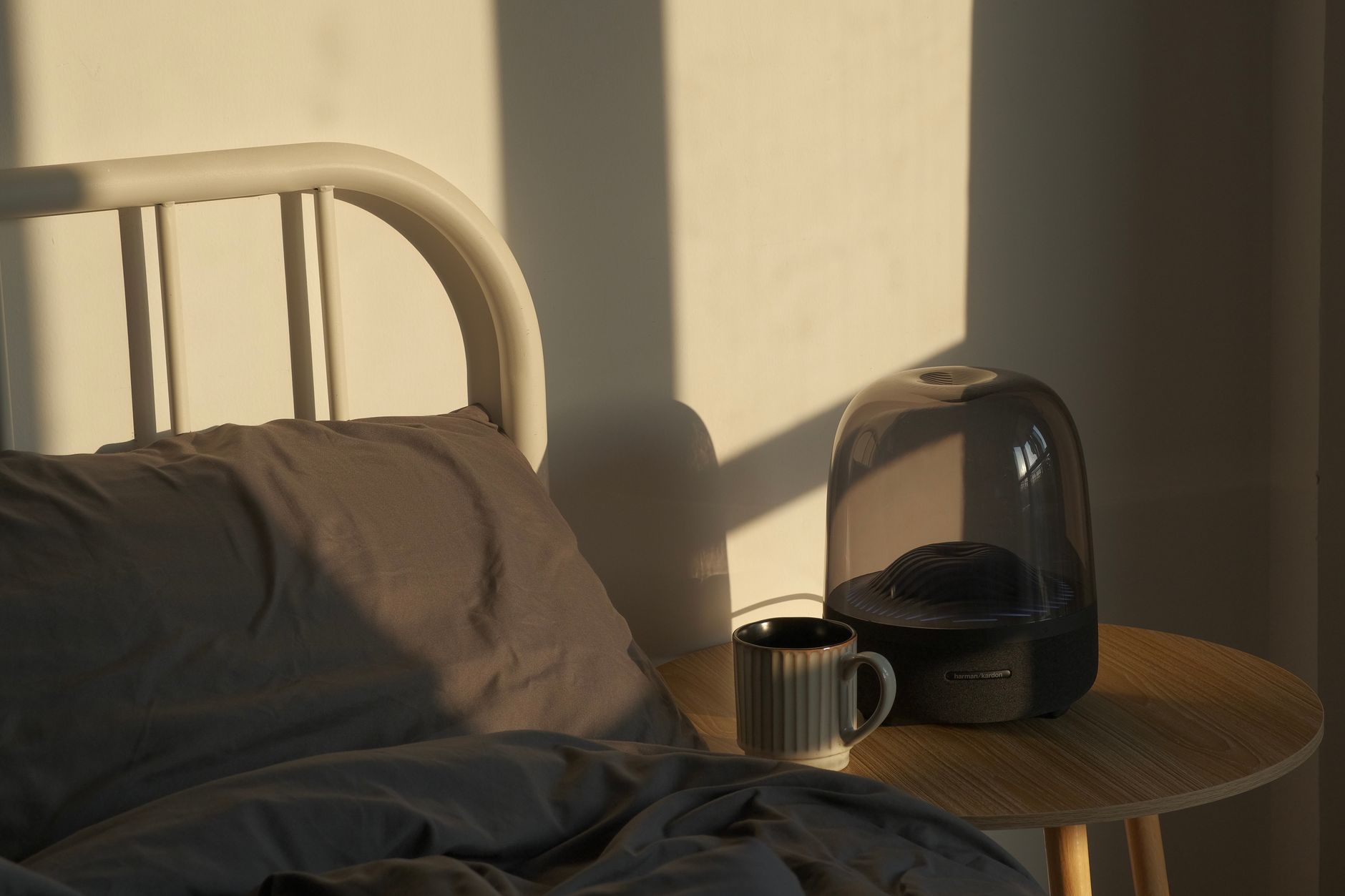 A minimalist and serene bedroom corner focused on comfort and soft light.