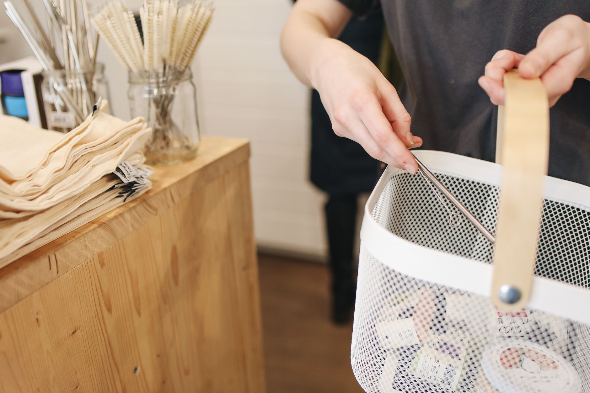 A collection of plastic-free, sustainable grocery items in a reusable bag.