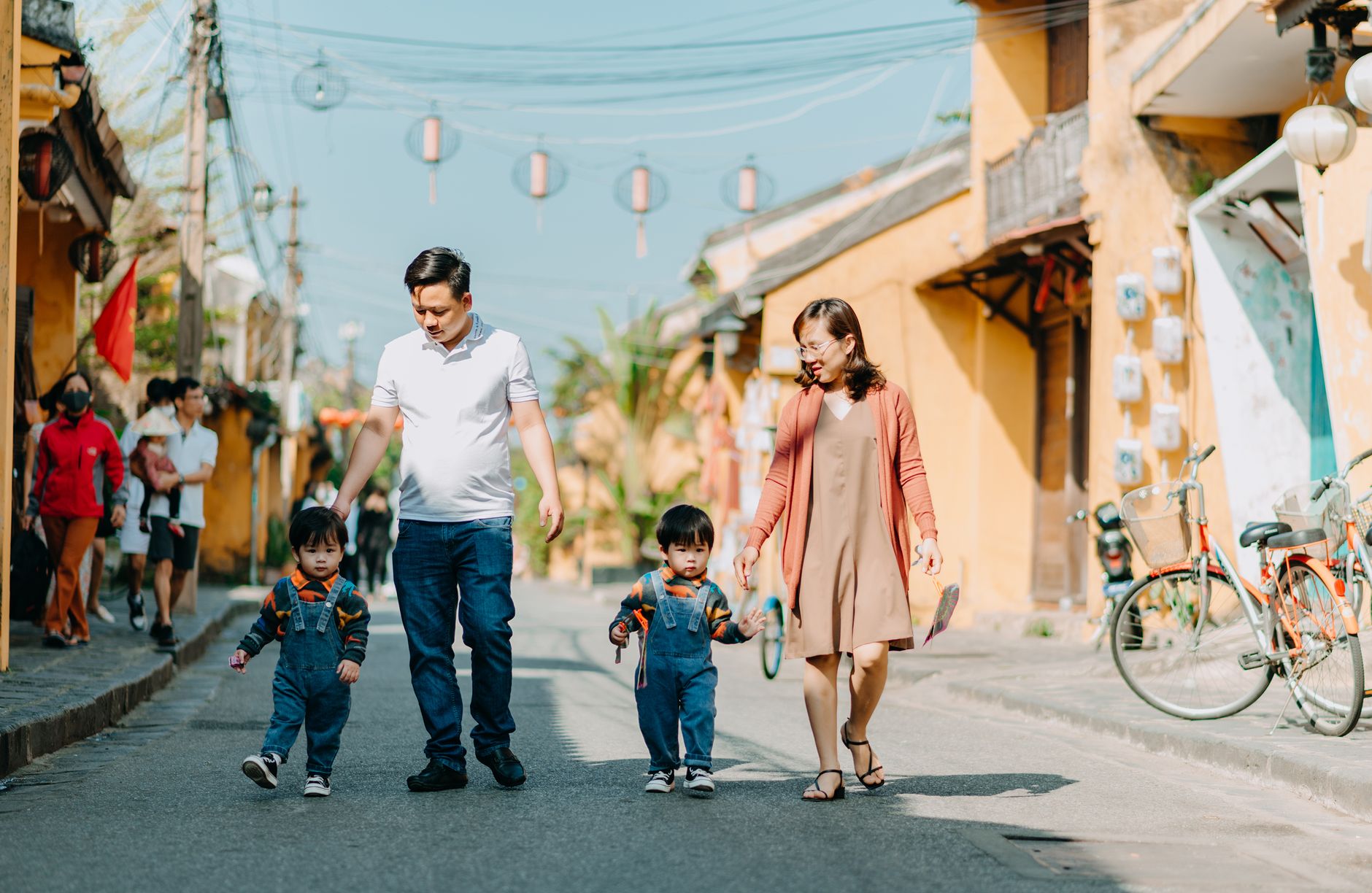 A parent and child exploring a local street at a relaxed pace.