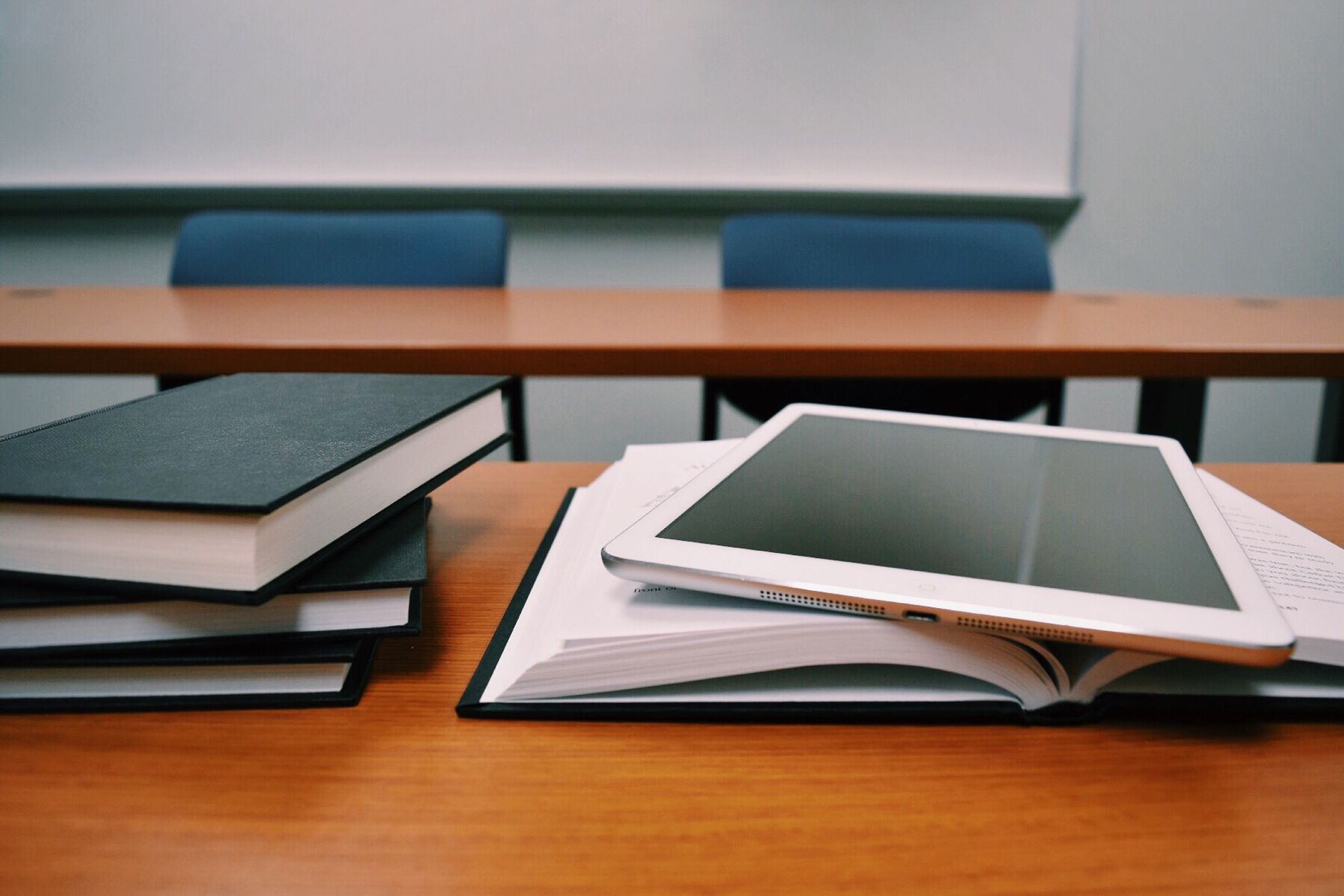 A juxtaposition of physical books and modern digital learning tools.