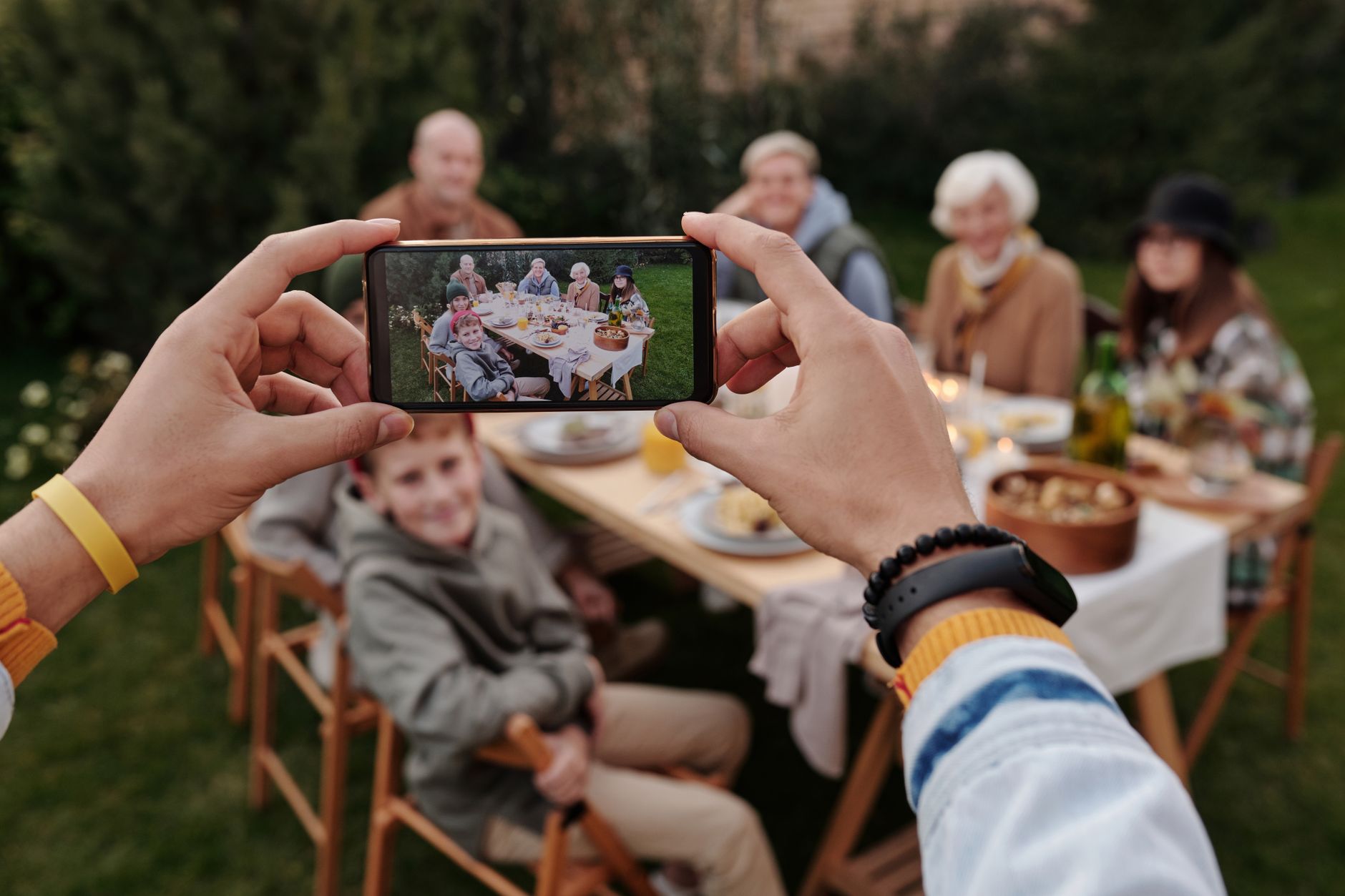 A family enjoying digital connectivity while traveling outdoors.