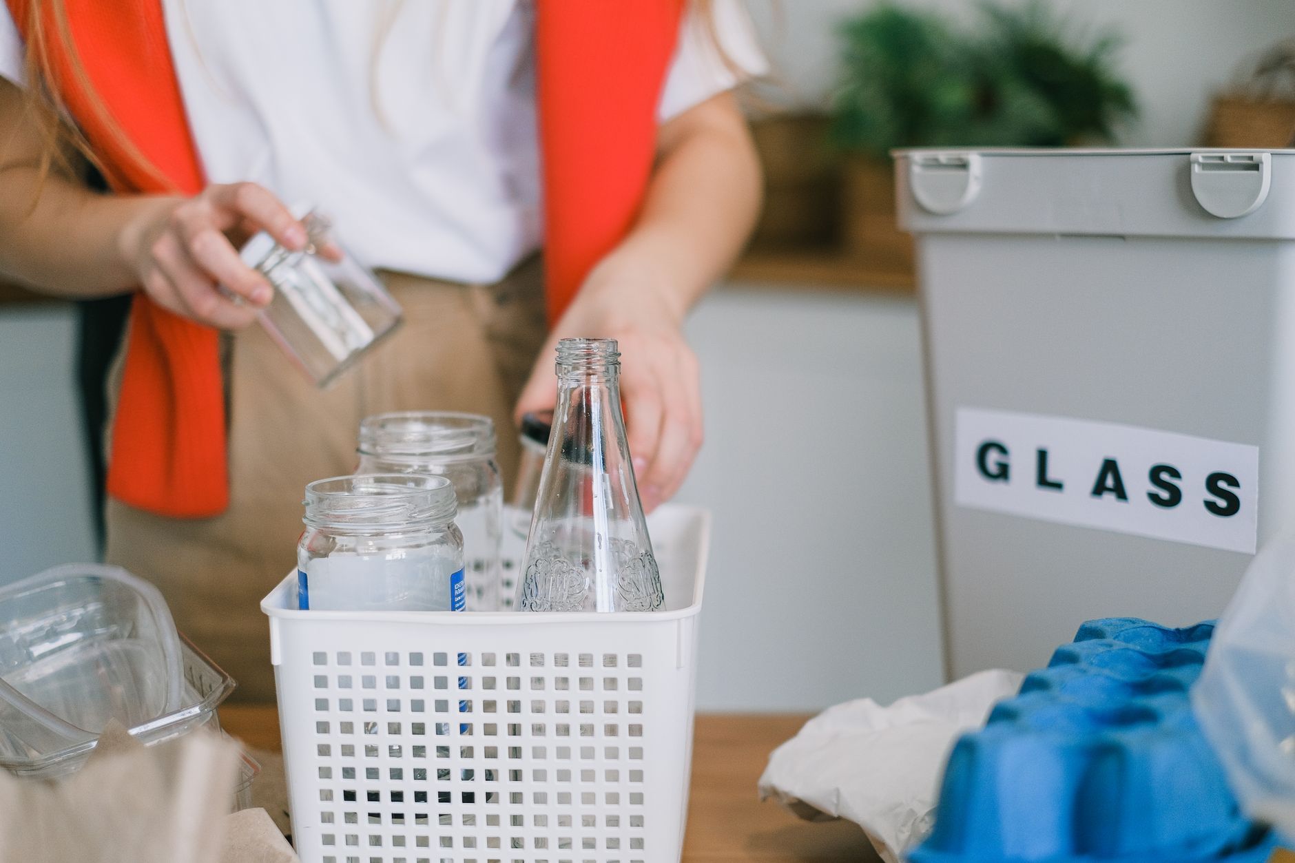A person choosing sustainable living practices in a home kitchen.
