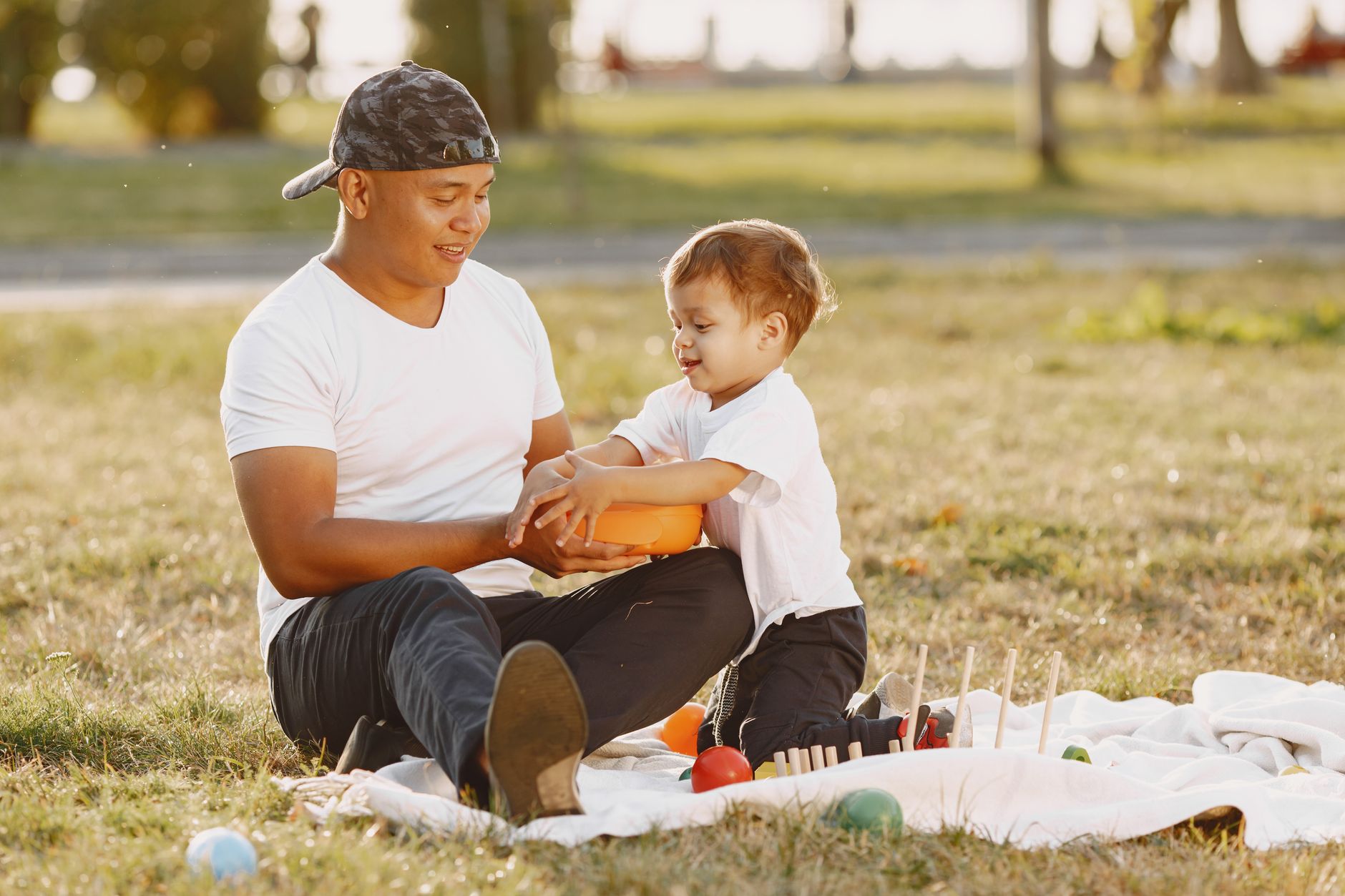 A parent and child in a park, illustrating the lifestyle of a digital nomad family.