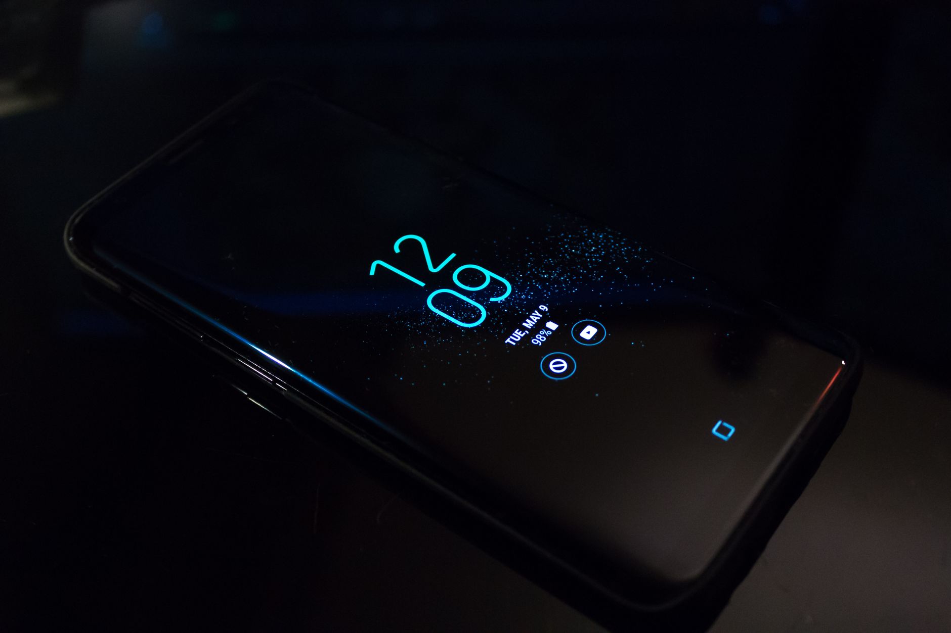 Digital clock in a dark, tech-free sleep environment.