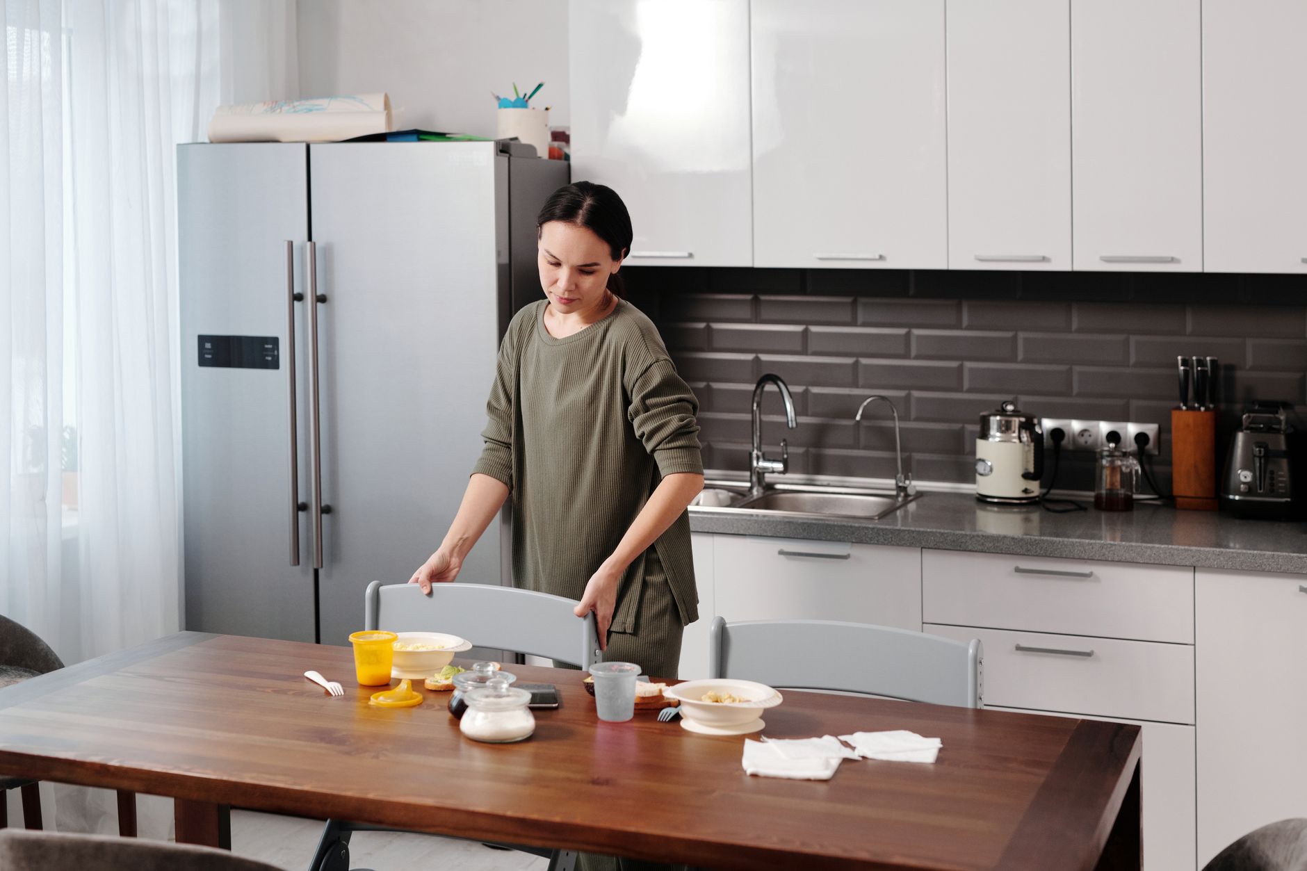 A family discussing appliance maintenance at their kitchen table.