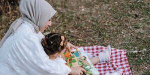 A parent and child bonding over books in a sunny home library.