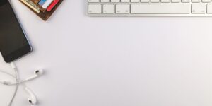 A smartphone and credit card on a desk, representing the need for a subscription audit.