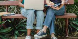 A thoughtful middle school student sitting on a park bench.