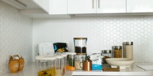A modern, sustainable kitchen setup with glass containers, representing a transition away from single-use plastics.