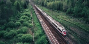 A scenic view of a high-speed train traveling through the European countryside.