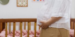 A cozy, sunlit nursery featuring curated pre-loved baby items.