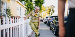 Neighbors interacting in a friendly suburban street setting.