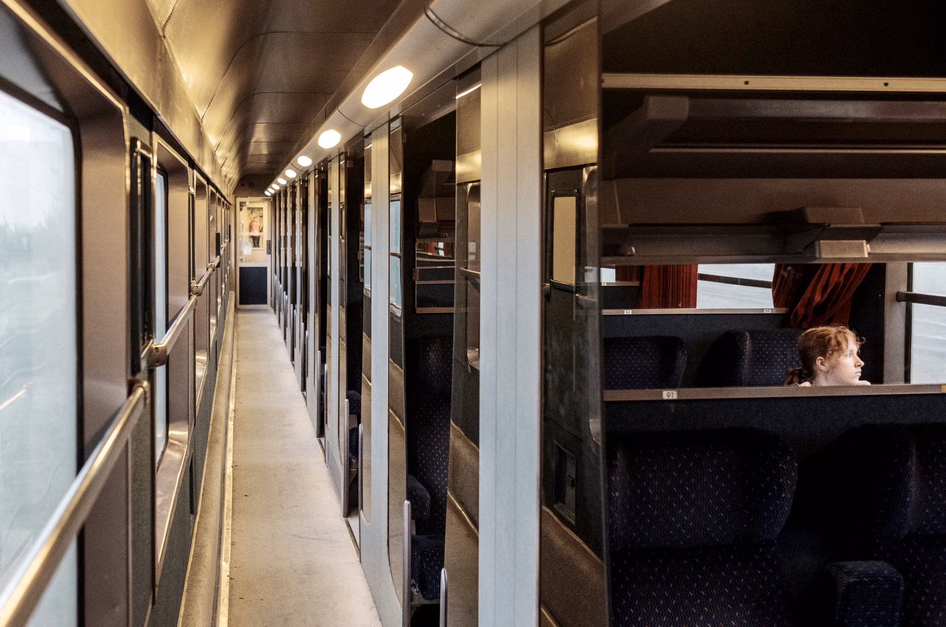 A family relaxing in a quiet train carriage.