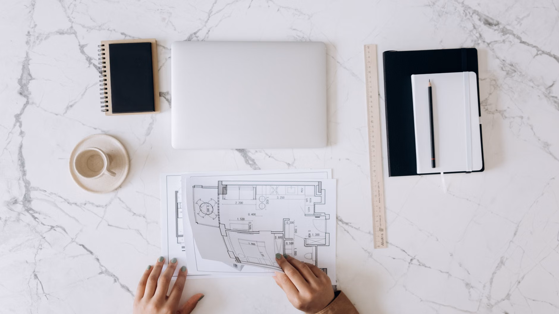 A person carefully planning their 30-day break at a home desk.