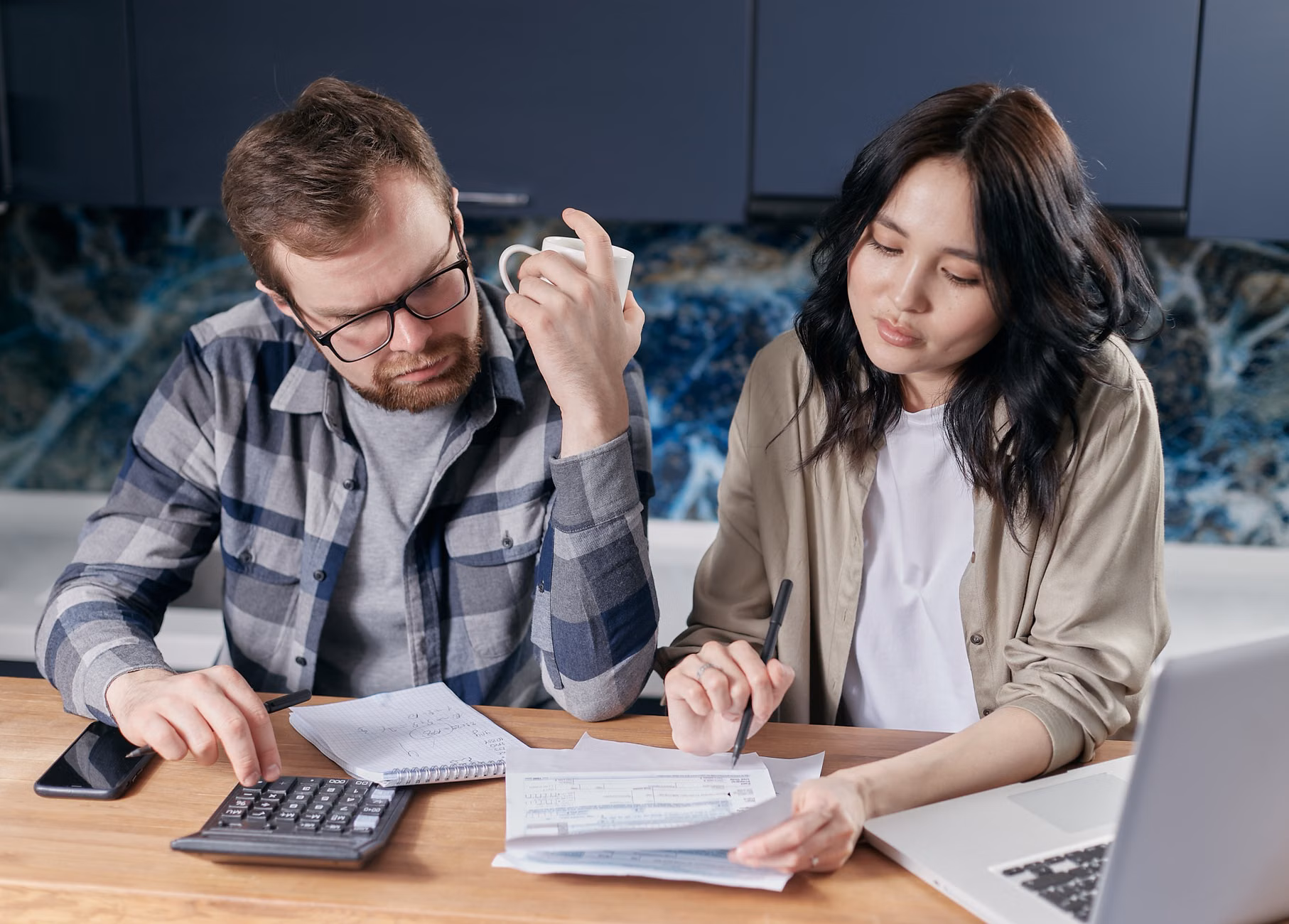 A couple reviewing their household budget and financial planning on a digital tablet.
