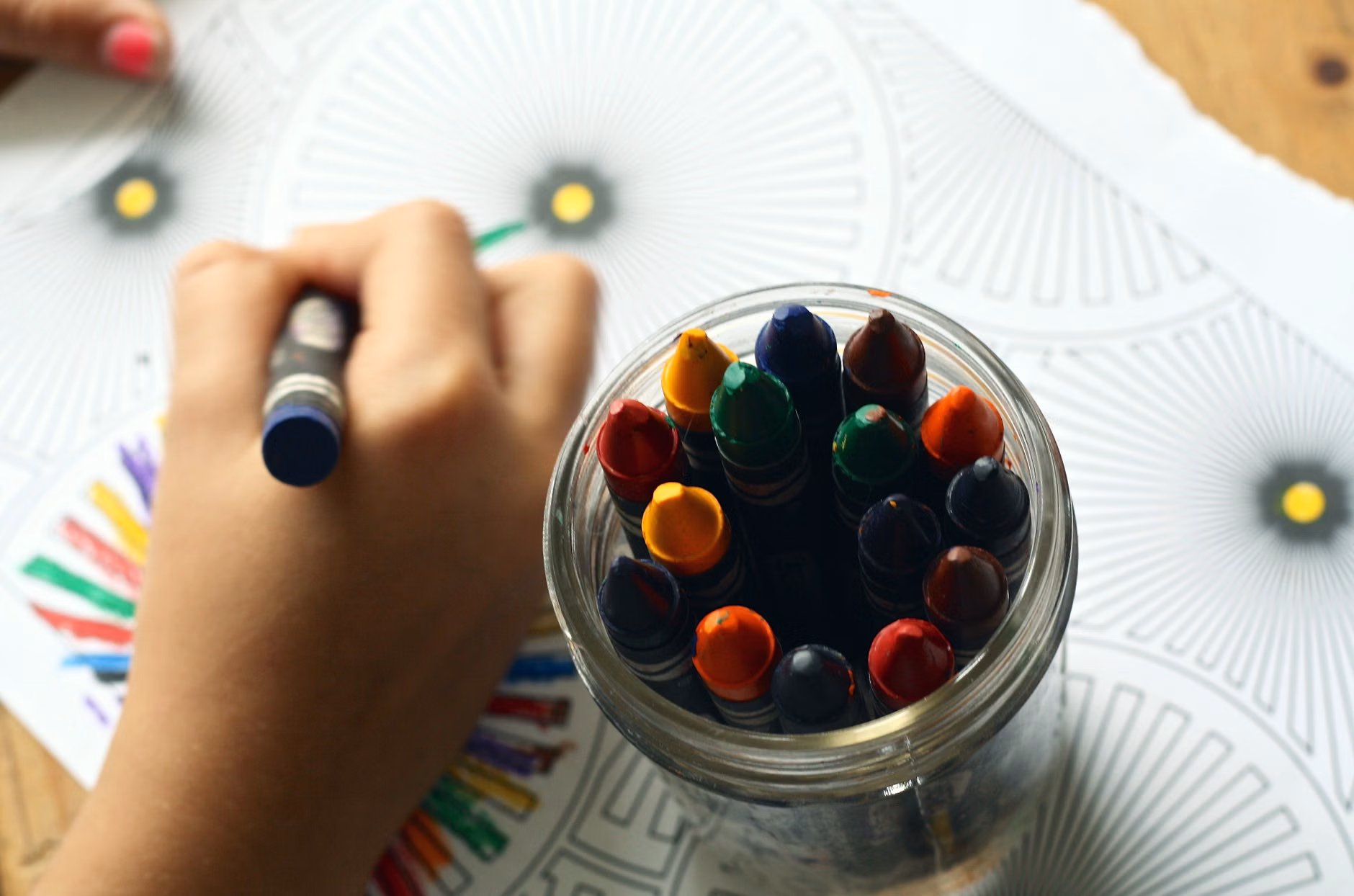 A child placing a note into an empathy jar.