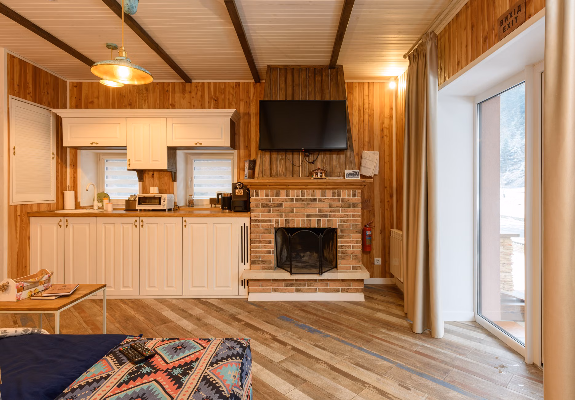 A cozy, quiet mountain cabin interior with a fireplace and mountain view.