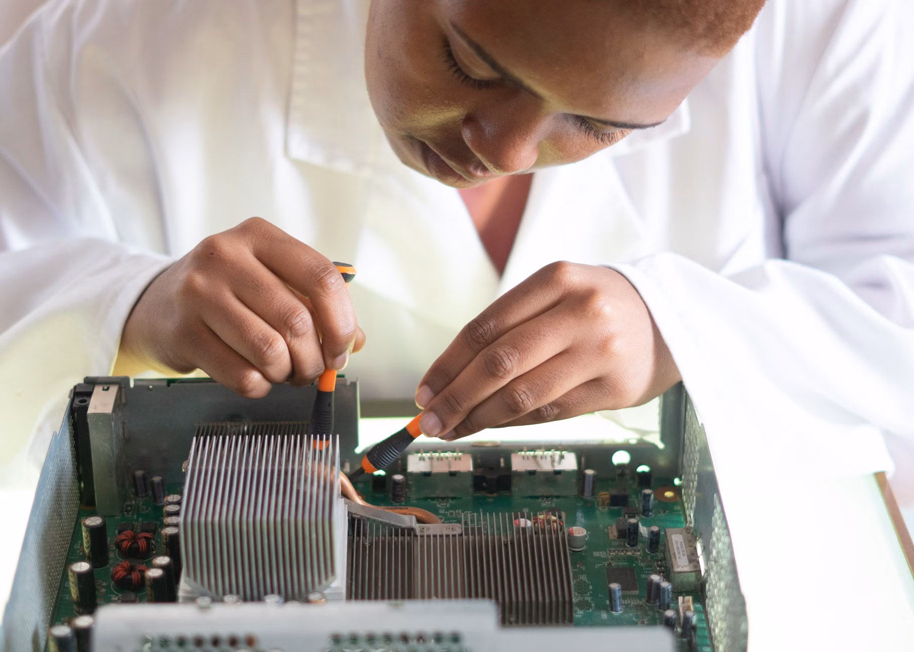 A professional technician inspecting the interior hardware of a premium laptop.