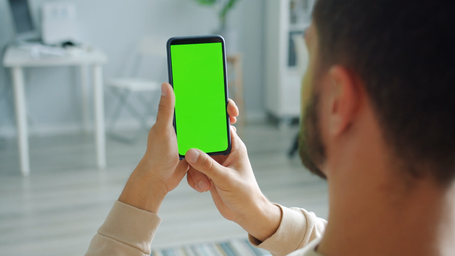 A parent checking energy consumption on a smartphone app.