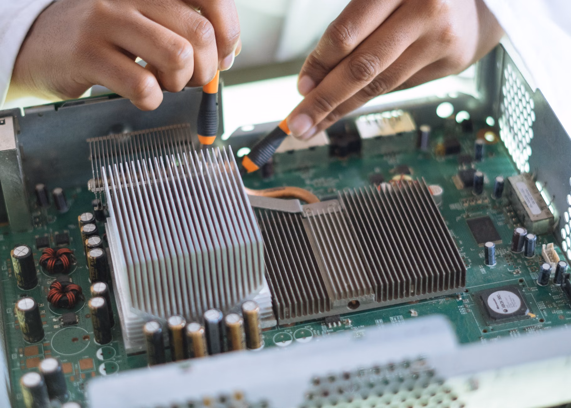 Close-up of a parent maintaining a used electronic device.