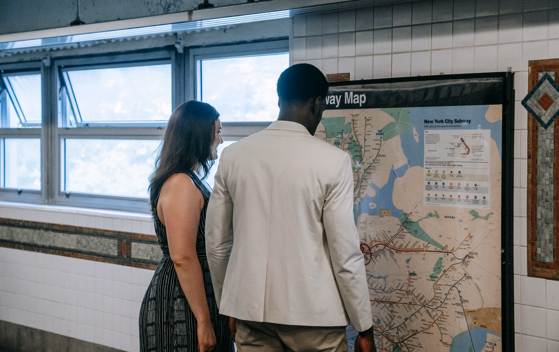 A parent and child reviewing a metropolitan transit map.