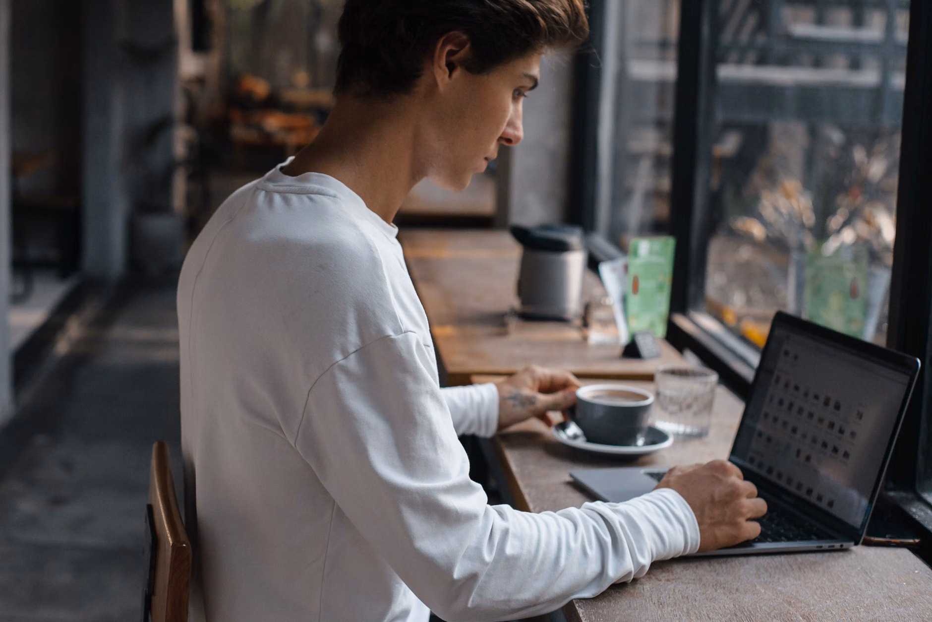 Digital nomad working in a cozy cafe setting.
