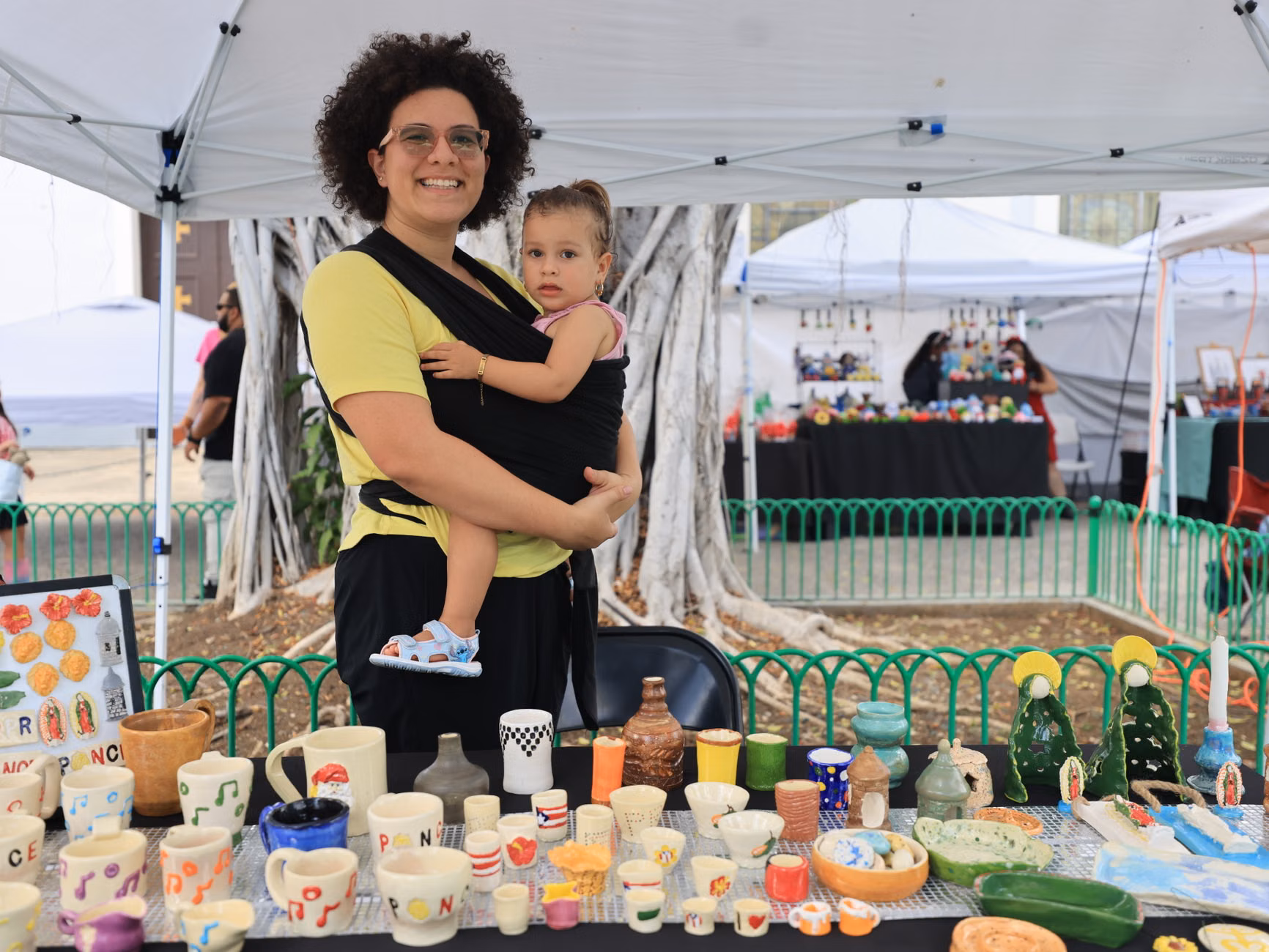 A child and parent engaging with a local craft stall at a micro-festival.