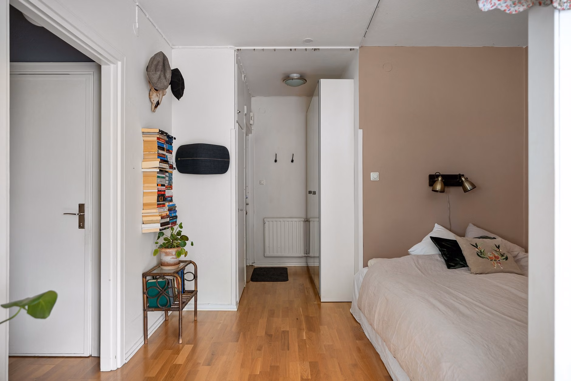 Wall-mounted floating shelf for books in a small apartment.