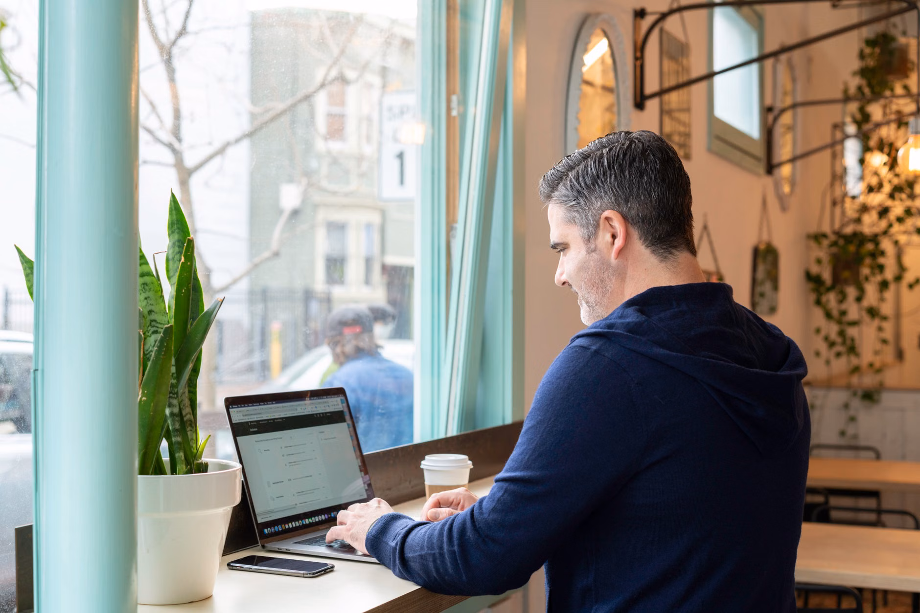 A professional working in a quiet cafe setting.
