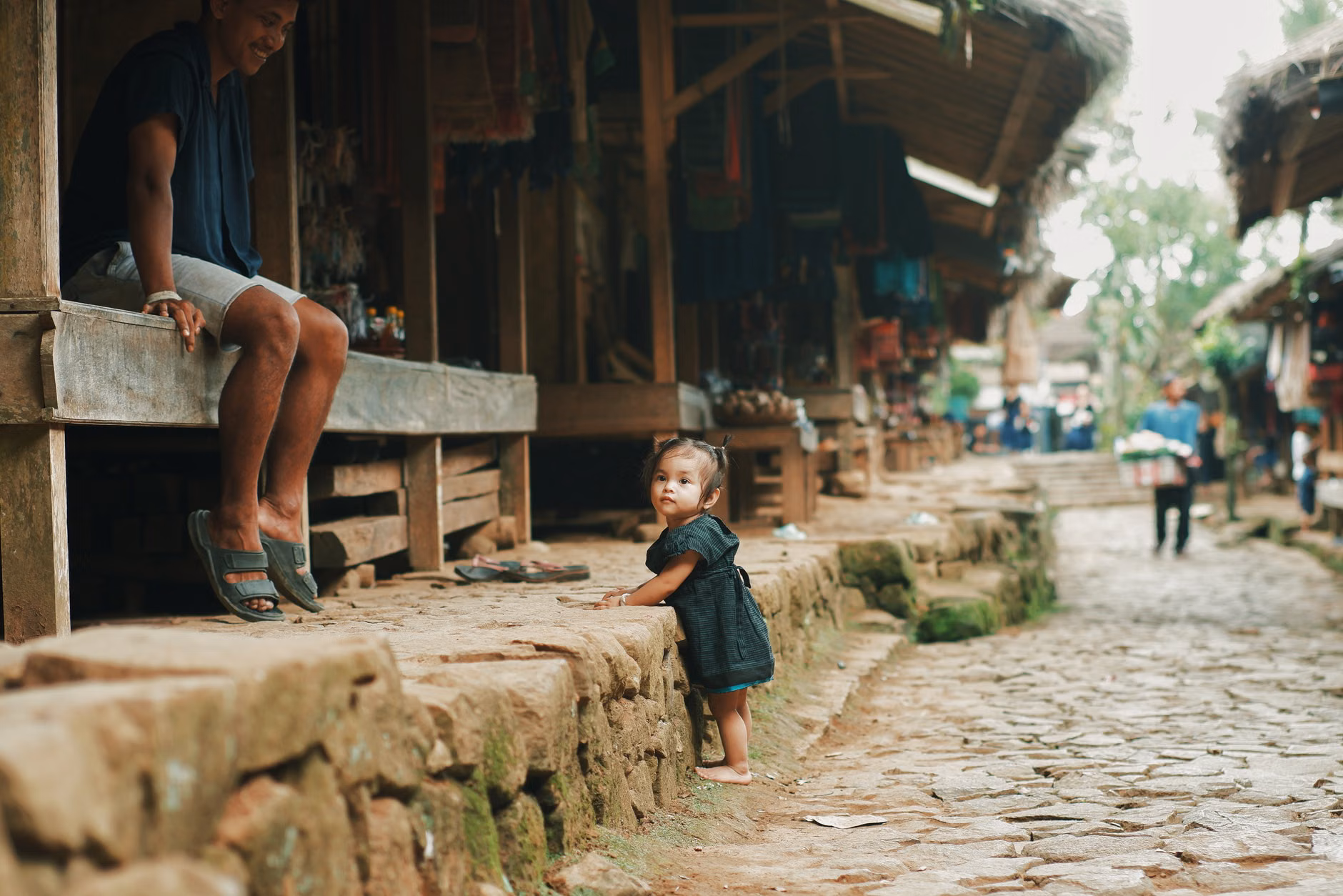 A family exploring an authentic village market during a trip.