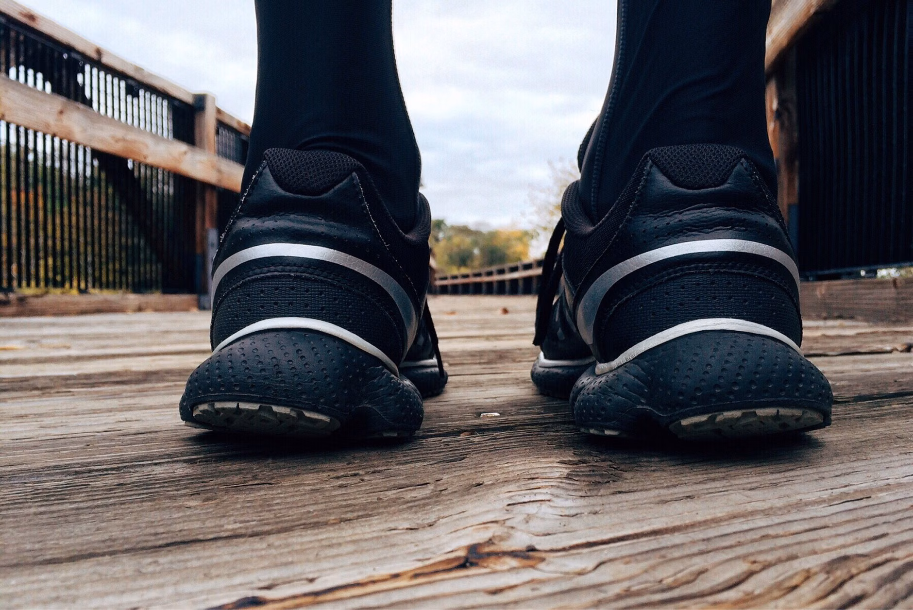 Running shoes on a trail representing the start of a new fitness goal.