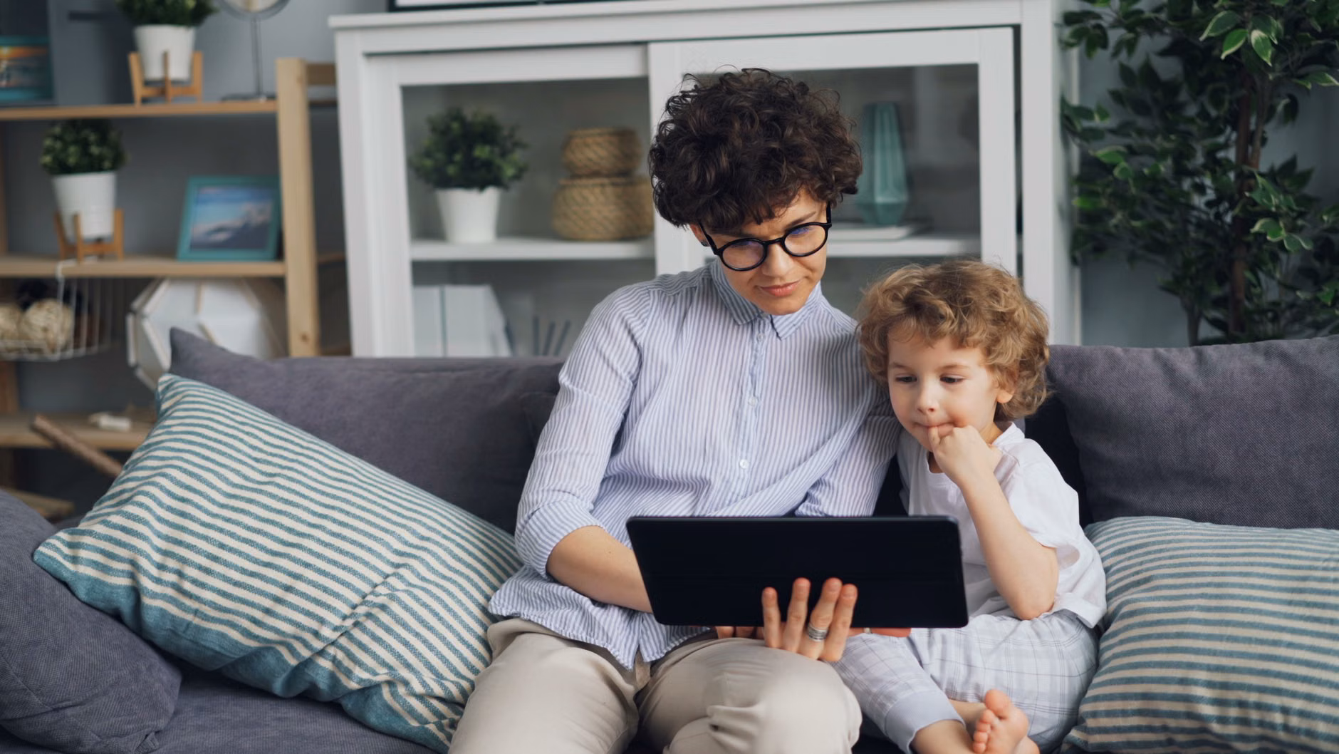 A family reviewing home energy consumption on a tablet.