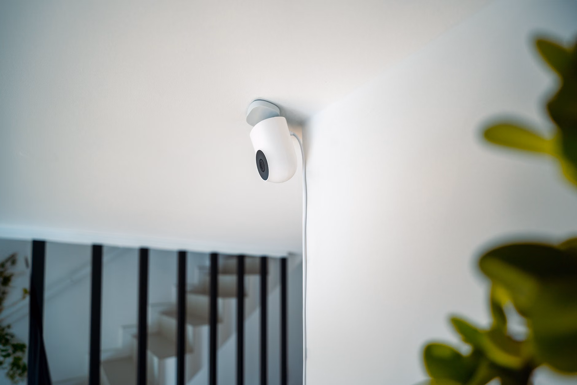 A discreet privacy-focused smart sensor mounted on a clean white wall.